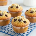 Freshly baked Greek yogurt banana oat muffins on a wooden table.