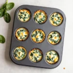 Crispy wonton cups filled with creamy spinach and artichoke dip on a serving platter